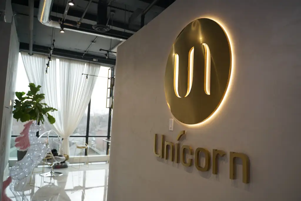 Unicorn Cosmetic Clinic reception: the lit logo and the wordmark on the wall